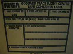 Pictured is the side of a blank Tape Container box. Boxes like these likely contain the tapes in question and have tracking information filled out on the label from when they were initially sent to the National Records Center. Each box can contain up to five data tapes.